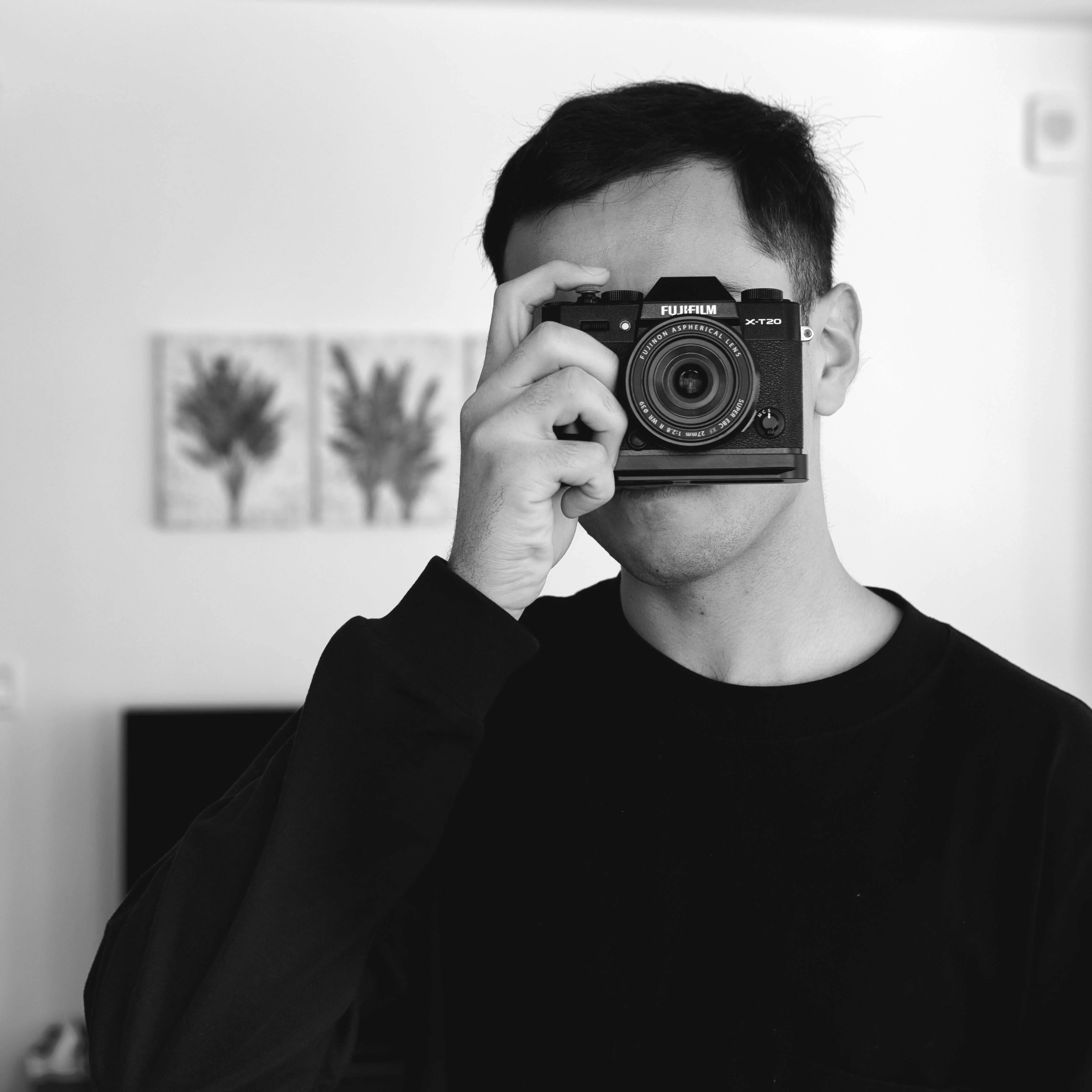 Bharat Suri holding a Fujifilm camera.